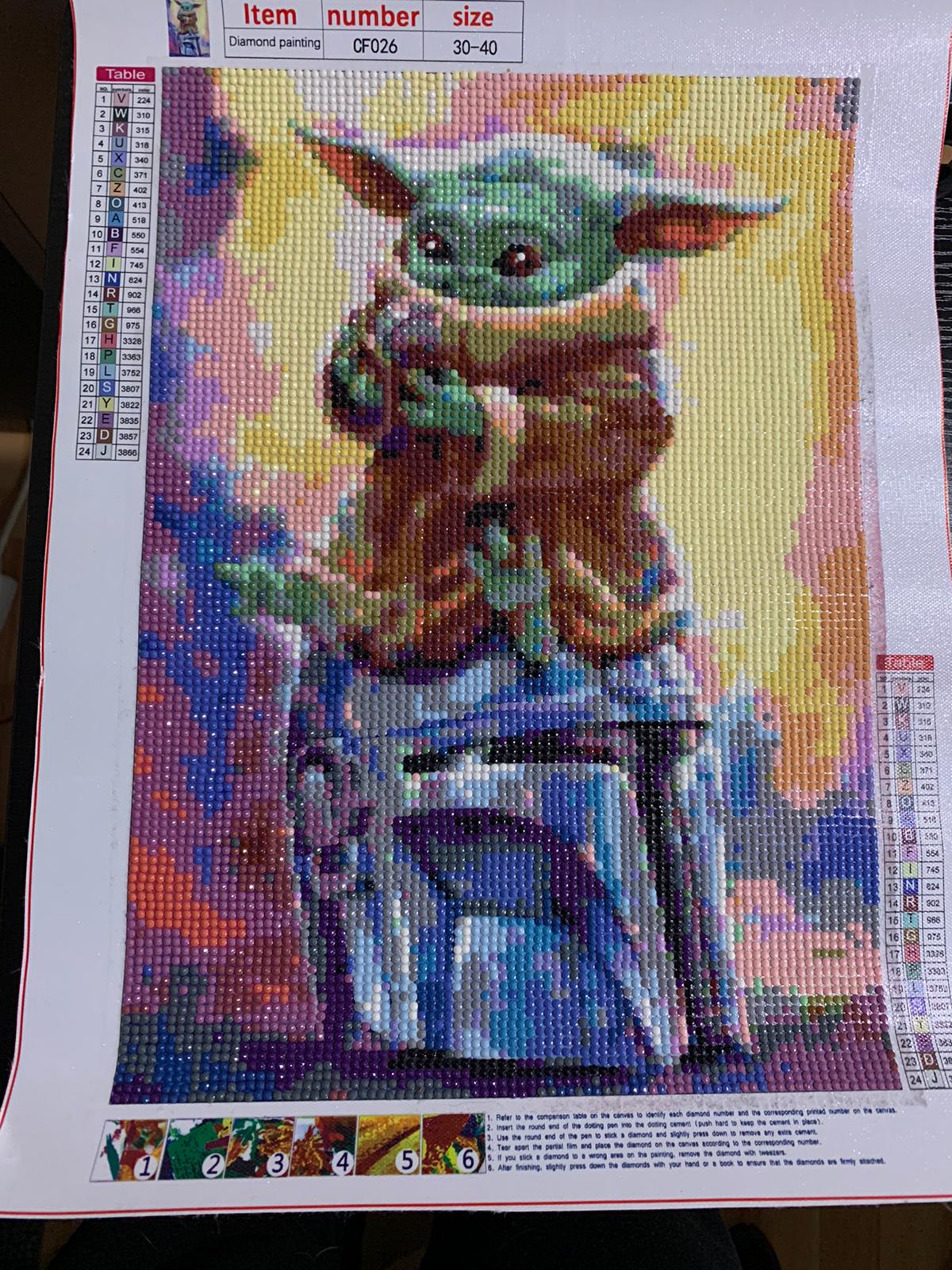 Primer cuadro de pintura diamante de Drioky, con Baby Yoda sobre el casco mandaloriano
